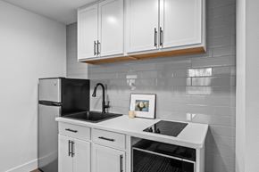 Pasco apartment for rent - a kitchen with white cabinets and black and white tiles